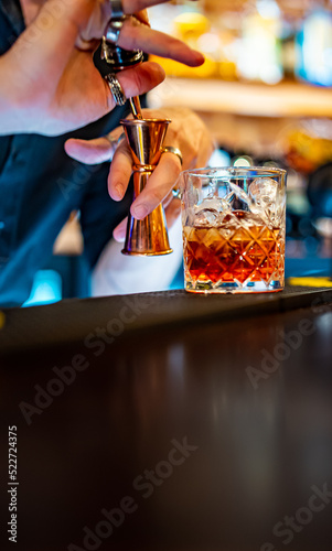 man bartender hand making cocktail in bar