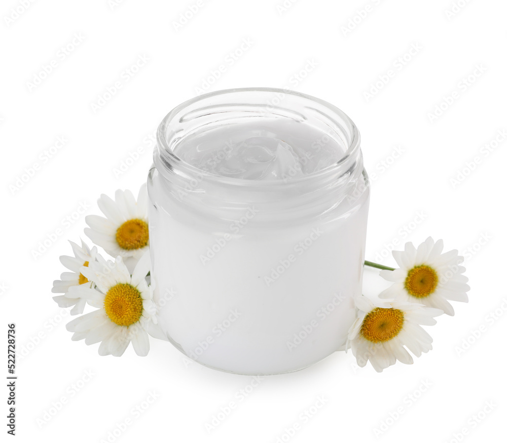 Jar of hand cream and chamomiles on white background