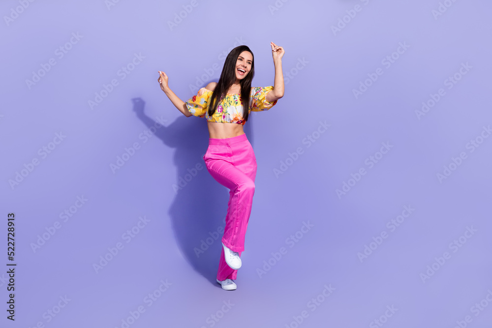 Full length photo of pretty funky girl dressed off shoulders blouse dancing empty space isolated purple color background Full length photo of pretty funky girl dressed off shoulders blouse dancing empty space isolated purple color background