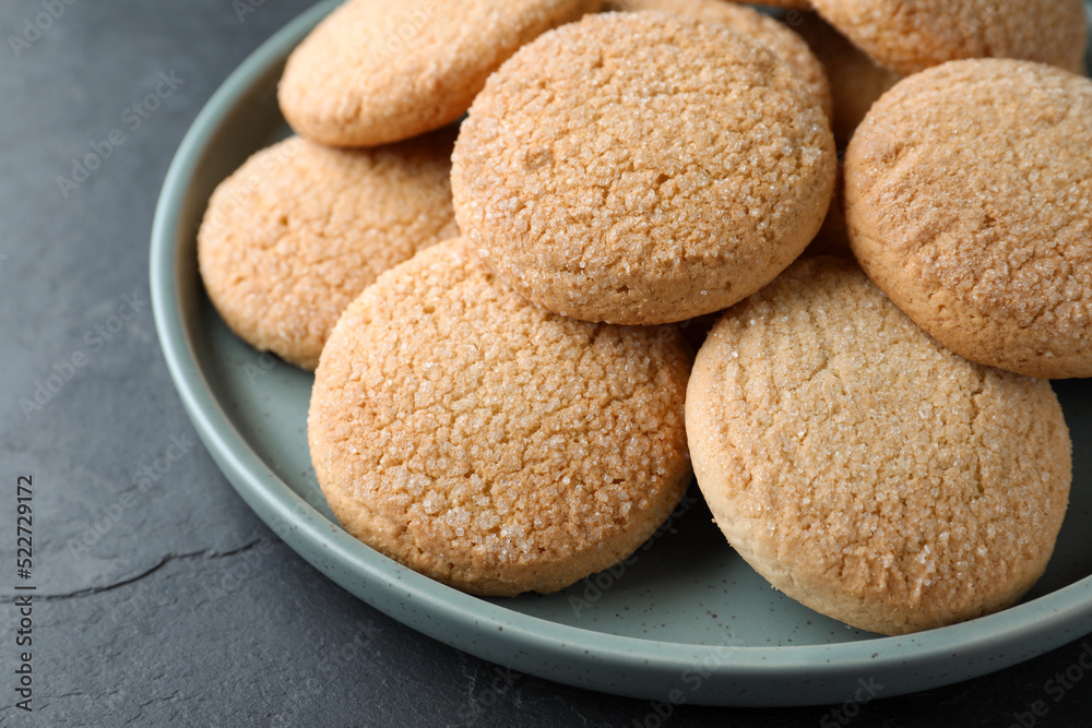 Delicious sugar cookies on black table, closeup Delicious sugar cookies on black table, closeup