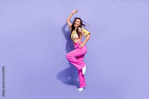 Full length portrait of adorable carefree person have good mood dancing isolated on purple color background