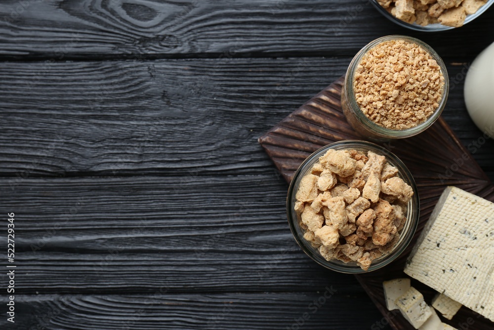 Different natural soy products on black wooden table, flat lay. Space for text Different natural soy products on black wooden table, flat lay. Space for text