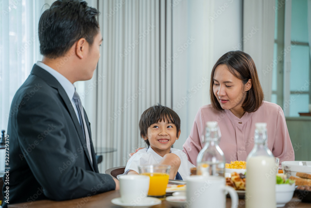 Happy family enjoying in their breakfast time in dining room before going to school. Happy family enjoying in their breakfast time in dining room before going to school.