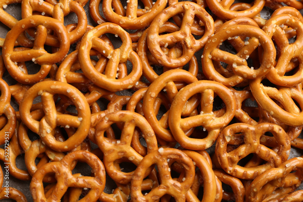 Many delicious pretzel crackers as background, top view Many delicious pretzel crackers as background, top view