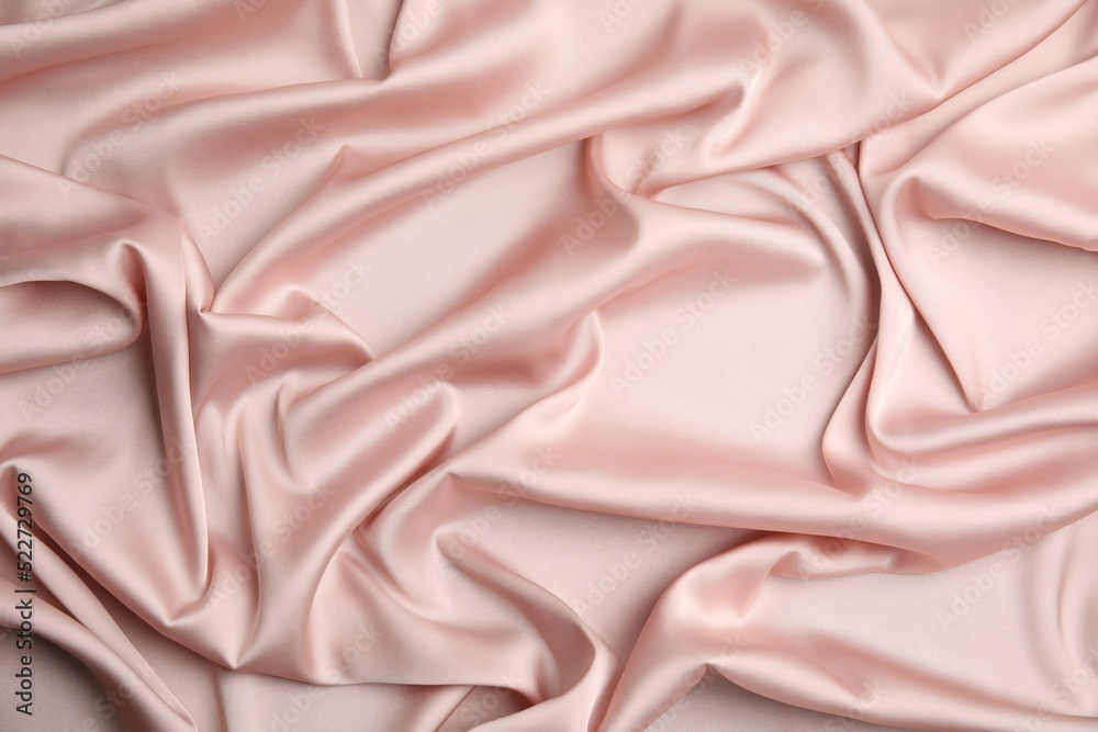 Fototapeta premium Texture of delicate pink silk as background, top view