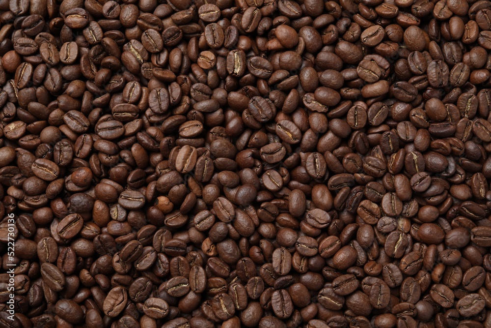 Pile of roasted coffee beans as background, top view