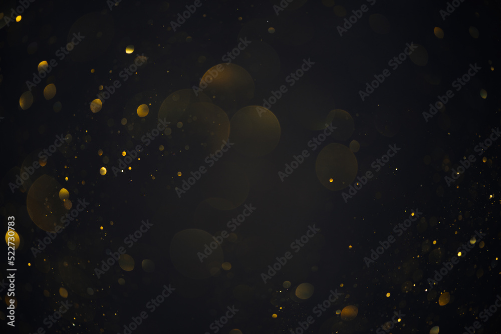 Obraz Golden bokeh lights sparkles of glitter dust particles dark abstract overlay background fototapeta, plakat