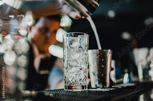 man bartender making cocktail in bar.