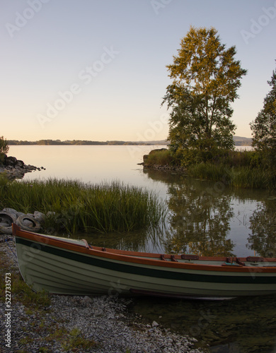 small fishing boat on the lake at sunrise