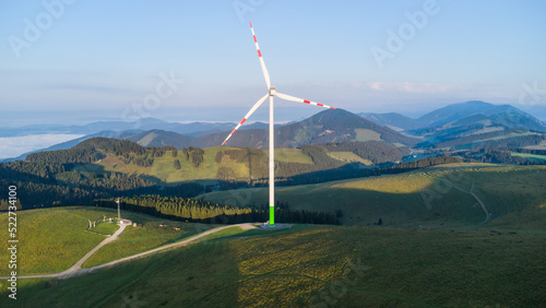 A wind power plant on a mountain ridge on a summer morning