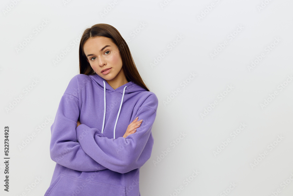 a relaxed woman stands on a white background in a purple suit calmly looks forward with her mouth slightly open and her arms crossed in front of her a relaxed woman stands on a white background in a purple suit calmly looks forward with her mouth slightly open and her arms crossed in front of her