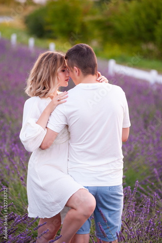 Young couple in love bride and groom, wedding day in summer. Enjoy a moment of happiness and love in a lavender field.