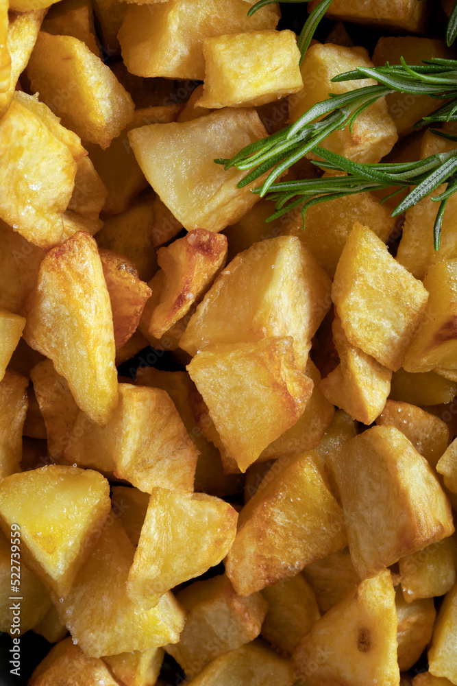 Macro close-up of homemade baked potatoes with rosemary. Macro close-up of homemade baked potatoes with rosemary.