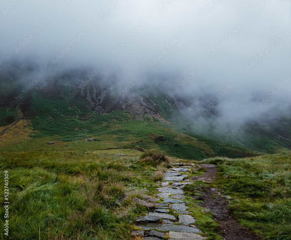 Cader Idris mountain with lake near the town of Dolgellau, in National Park Snowdonia in Wales, misty morning 2022. Cader Idris mountain with lake near the town of Dolgellau, in National Park Snowdonia in Wales, misty morning 2022.