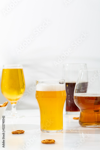 Several glass with beer brown and light on light surface refreshment cold beverages
