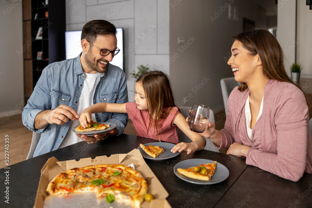 Portrait of happy family sharing pizza at home Portrait of happy family sharing pizza at home