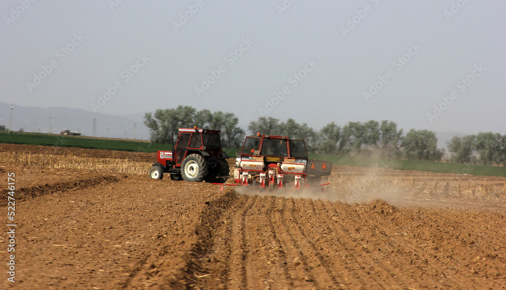 Fototapeta premium Tractor of farmer plowing the field before planting.