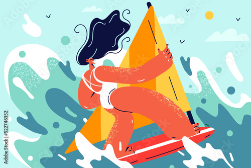 Happy woman windsurfing in sea