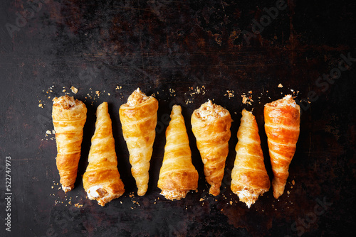 Puff pastry horns filled with Italian meringue, Schaumrollen o Cream Horns photo