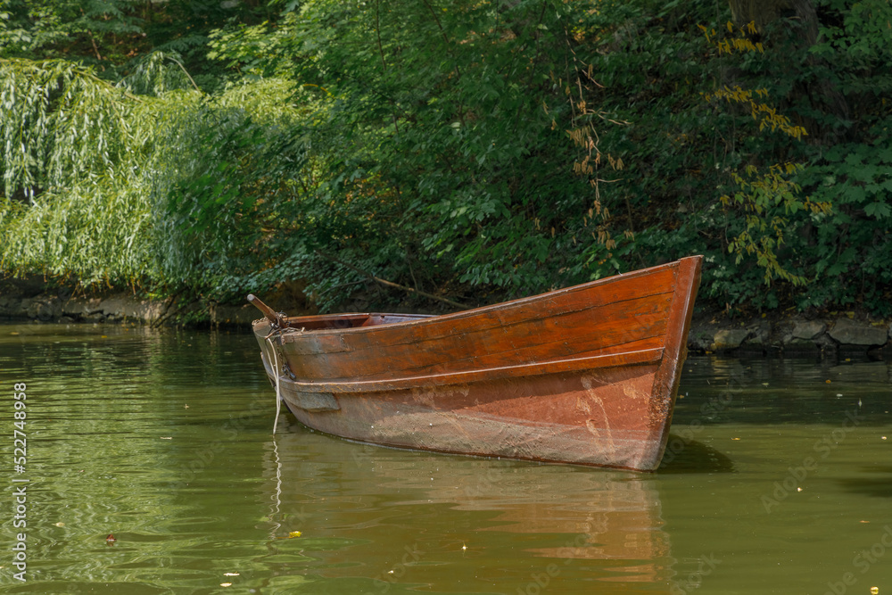 Large wooden pleasure boat in the city park Sofiyivka Uman city Large wooden pleasure boat in the city park Sofiyivka Uman city