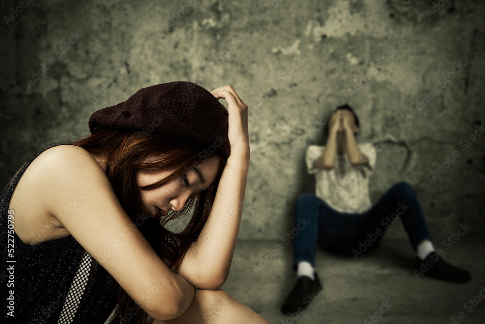 Naklejka premium Sad young couple sitting in abandoned house