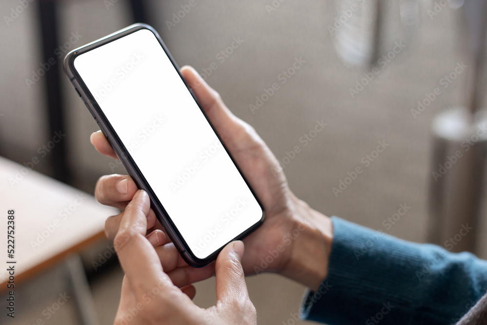 cell phone blank white screen mockup.hand holding texting using mobile on desk at office.background empty space for advertise.work people contact marketing business,technology