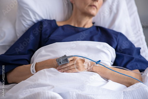 Obraz na płótnie Pulse oximeter on senior patient's hand at hospital