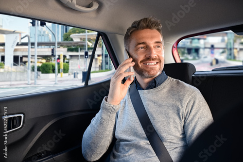 Wallpaper Mural Happy mature man in taxi talking on phone