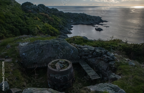 Vanse, Norway - May 30, 2022: Varnes Fort is an ex-German coastal battery a little east of Varnes lighthouse. The battery was set up with four 105mm and about 100 men. Selective focus. photo