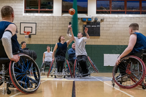 Men in wheelchairs playing basketball © Cultura Creative