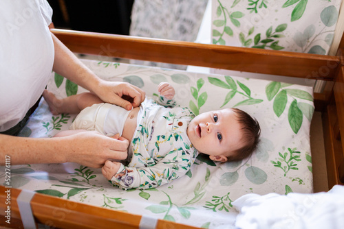 Happy baby on change table getting nappy changed ready for the day