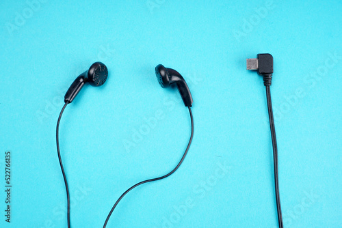 Top view of Mobile phone with headphones isolated on colorful background, Listen to music. Space for text