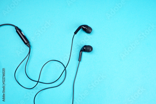 Top view of Mobile phone with headphones isolated on colorful background, Listen to music. Space for text