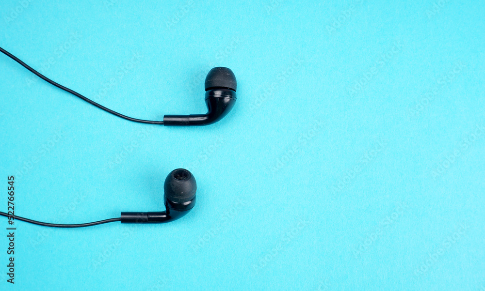 Top view of Mobile phone with headphones isolated on colorful background, Listen to music. Space for text Top view of Mobile phone with headphones isolated on colorful background, Listen to music. Space for text
