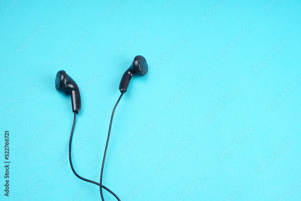 Top view of Mobile phone with headphones isolated on colorful background, Listen to music. Space for text Top view of Mobile phone with headphones isolated on colorful background, Listen to music. Space for text