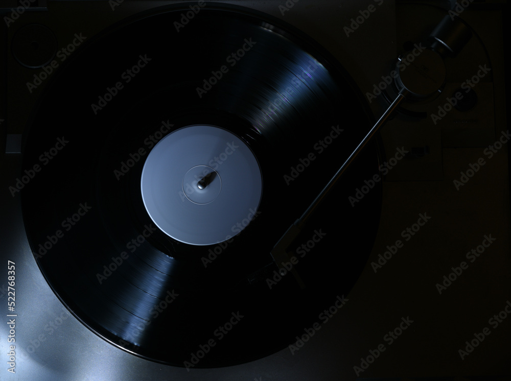 rim light on turntable in blue light playing vinyl record