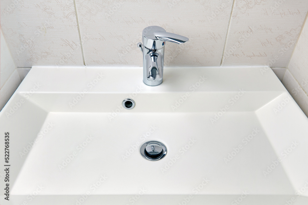 Rectangular washbasin in the bathroom after cleaning and disinfection. Cleaning plumbing in the house. Rectangular washbasin in the bathroom after cleaning and disinfection. Cleaning plumbing in the house.
