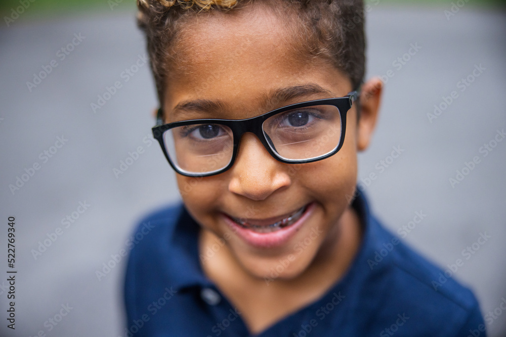 Close up image of a cute african american boy with glasses and a big smile Close up image of a cute african american boy with glasses and a big smile
