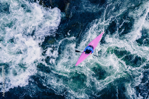 Top view boat of kayaker on mountain rough blue river, extreme sport kayak, aerial drone photo