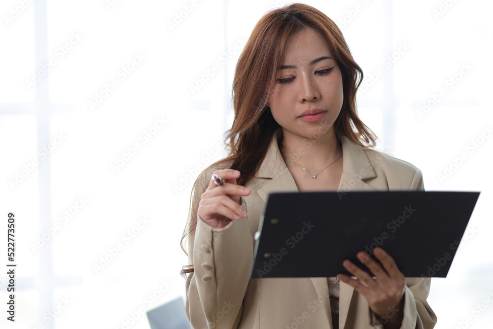 Businesswoman reading documents and analyzing work schedule. Businesswoman reading documents and analyzing work schedule.
