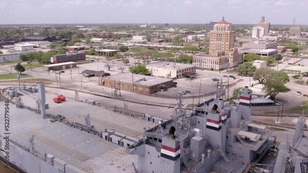 Aerial Shot Of Factory Buildings On Landscape During Sunny Day, Drone Flying Forward Over Cargo Ships - Beaumont, Texas Aerial Shot Of Factory Buildings On Landscape During Sunny Day, Drone Flying Forward Over Cargo Ships - Beaumont, Texas