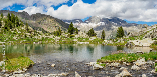 Perramo lake and Perdiguero peak at baclground in Benasque Valley, Spain photo