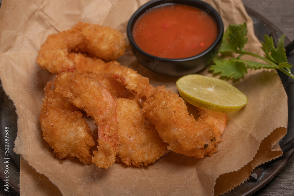 Breaded and breaded shrimp with chilli sauce on black background Breaded and breaded shrimp with chilli sauce on black background