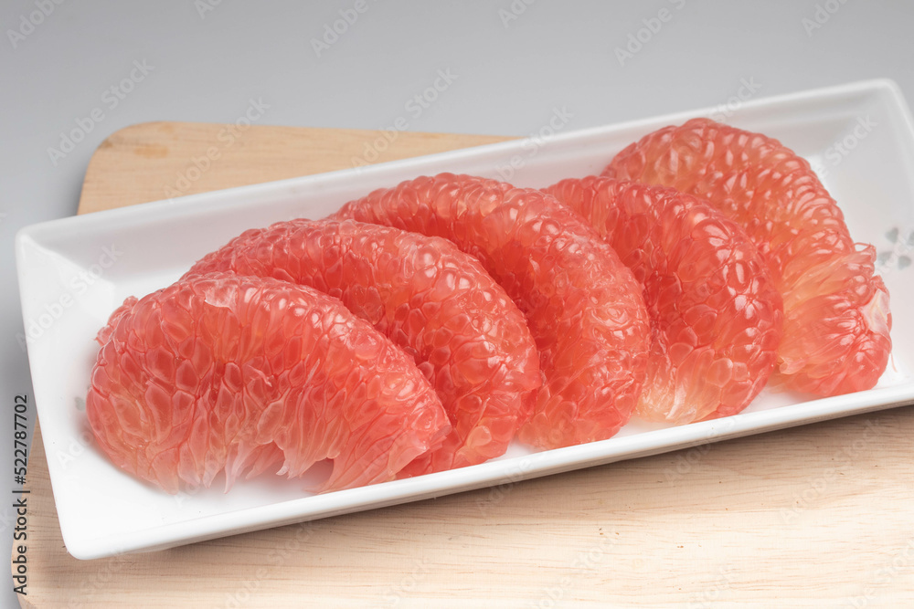 Red Pomelo or Grapefruit on a wooden floor