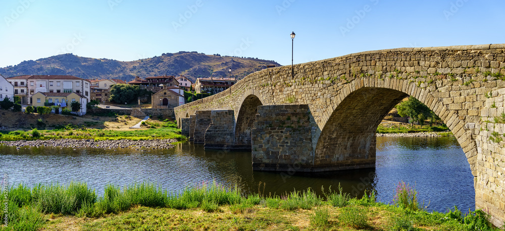 Medieval stone bridge over the River Tormes as it passes through the old village of Barco de Avila, Spain.