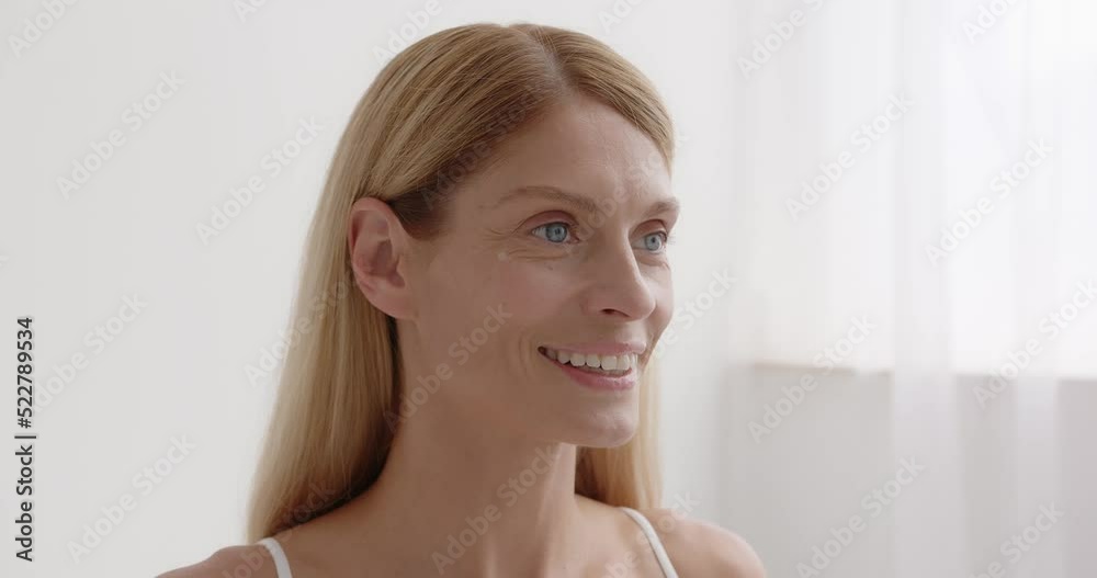 Senior woman using anti wrinkle serum in the bedroom Senior woman using anti wrinkle serum in the bedroom