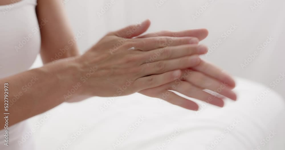 Middle age woman pouring cream on hand sitting on bed at bedroom closeup Middle age woman pouring cream on hand sitting on bed at bedroom closeup
