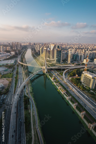 Fototapeta Naklejka Na Ścianę i Meble -  Aerial view of Octavio Frias de Oliveira Bridge (Ponte Estaiada) over Pinheiros River at sunset - Sao Paulo, Brazil