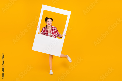 Full size photo of youngster sweet lady hold white photograph border enjoy camera shooting isolated shine color background