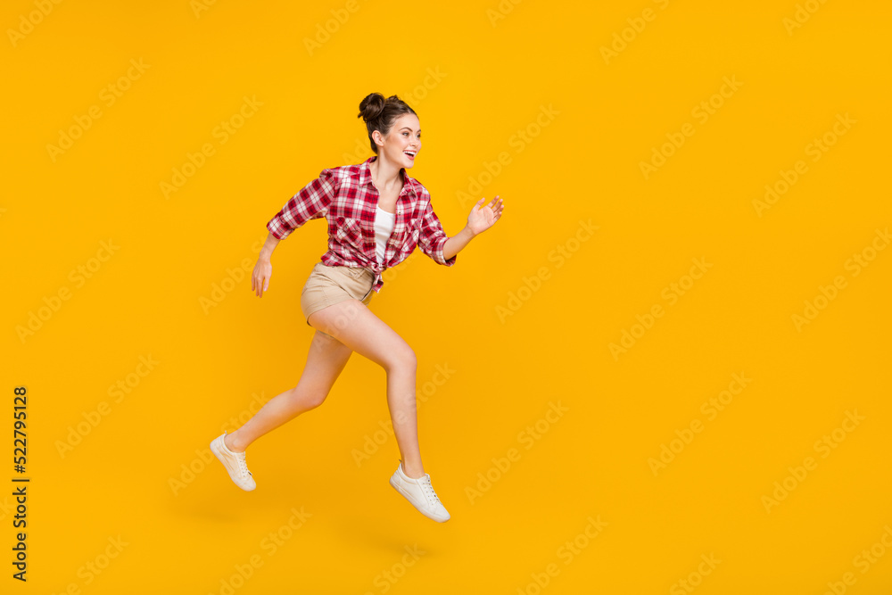 Full size profile portrait of excited active lady hurry fast look empty space isolated on yellow color background